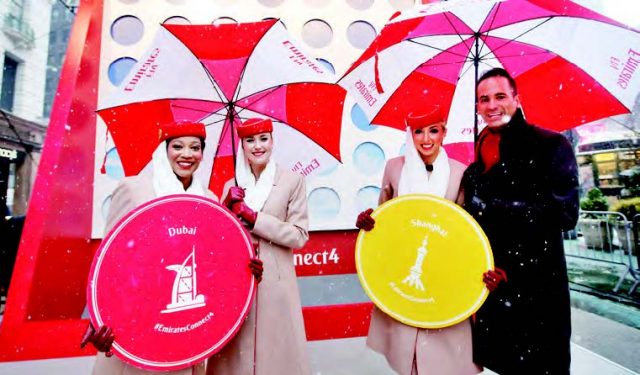 Emirates Cabin Crew mark the celebration of Emirates' fourth daily service from John F. Kennedy International Airport beginning March 8 with a giant Connect 4 Hasbro game in New York's Herald Square, Thursday, March 5, 2015.