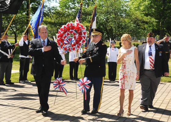 Nassau County Executive Edward Mangano (2nd left), County Legislator Laura Schaefer, keynote speaker Colonel Anthony Hartmann and United Veterans Organization’s President Rick Gales present a floral wreath at the 2015 United Veterans Organization’s Memorial Day Ceremonies at Veterans Plaza in Eisenhower Park.