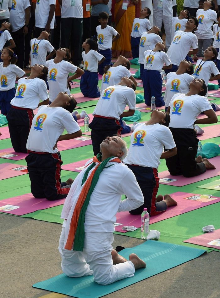 New Delhi: Prime Minister Narendra Modi performs yoga along with thousands of others at a mass yoga session to mark the International Day of Yoga 2015 at Rajpath in New Delhi on Sunday. PTI Photo by Atul Yadav(PTI6_21_2015_000014B)