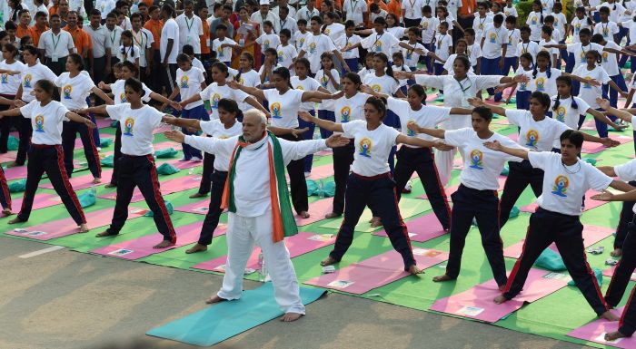 New Delhi: Prime Minister Narendra Modi performs yoga along with thousands of others at a mass yoga session to mark the International Day of Yoga 2015 at Rajpath in New Delhi on Sunday. PTI Photo by Atul Yadav(PTI6_21_2015_000026B)