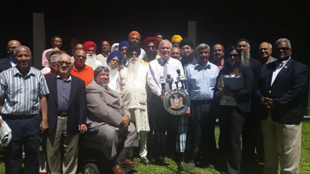 Senator Avella (center) stands with community leaders, advocacy groups and representatives of the Hindu, Sikh and Islamic faiths, to speak on his bill to recognize these three faiths in the New York State religious corporation law