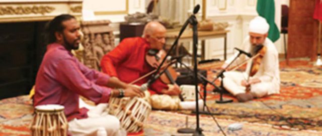 Pt. Dinesh Kumar Prabhakar (center) performs. He is accompanied on Tabla by Avirodh Sharma (left) and on Violin Daljeet Singh Sokhey (right).