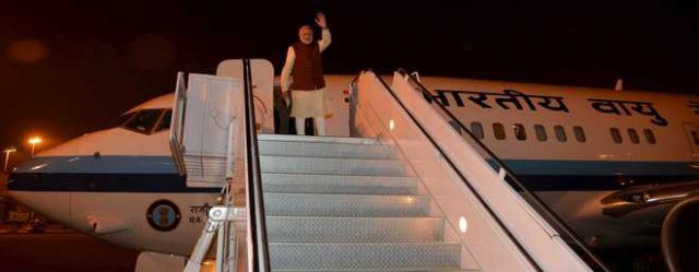 Prime Minister Narendra Modi waves from a plane after meeting his Pakistan counterpart Nawaz Sharif in Lahore on Friday. REUTERS