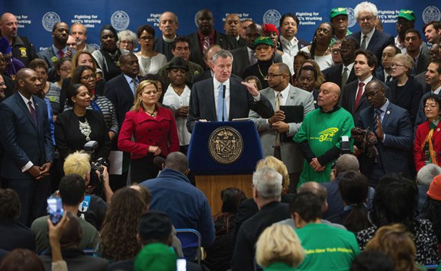 New York City Mayor Bill de Blasio announced, January 6, guaranteed $15 minimum wage for all City government employees. Council Speaker Mark Viverito is seen to the right of the Mayor Photo courtesy Mayor's Office