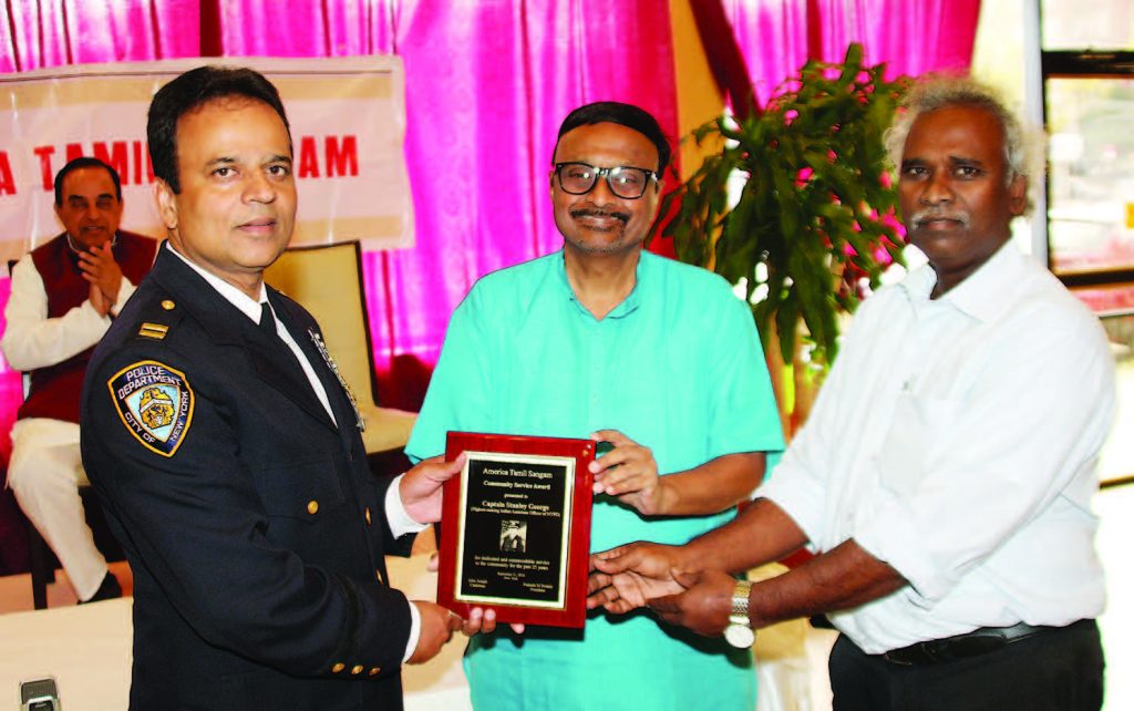 Prakash M Swamy, president and John Joseph, Chairman of the Sangam present the award to Capt. Stanley George