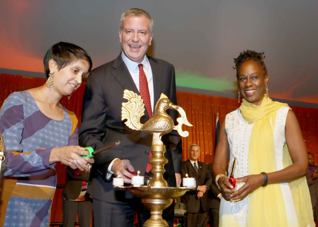 Nisha Agarwal, Immigrant Rights Commissioner, New York City (left); Mayor Bill de Blasio (center) and his wife Chirlane McCray (right) light up the traditional lamp on the occasion of Diwali Celebration at Gracie Mansion, Mayor's official residence in New York, October 19