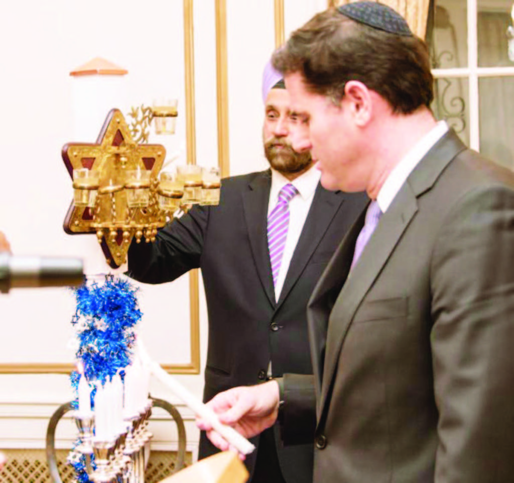 Lighting of the Menorah at the Hanukkah celebrations at Ambassador Sarna's Residence. Ambassador of Israel Ron Dermer (seen in the foreground) and Ambassador of India Navtej Sarna lighting the Menorah.