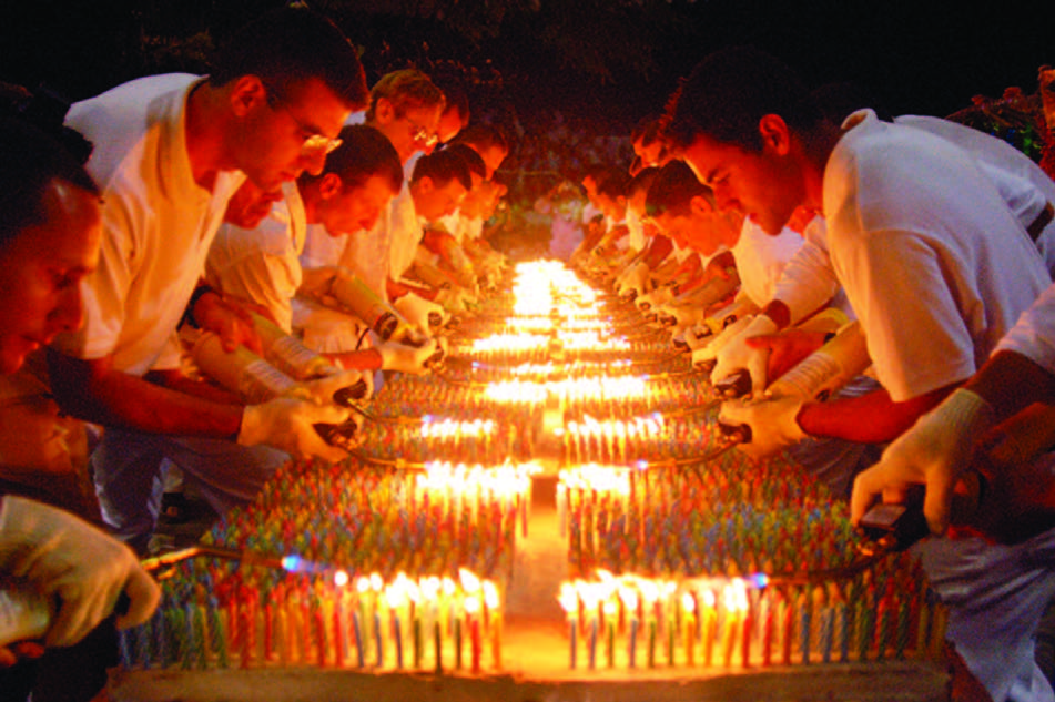 Sri Chinmoy's followers in USA set a Guinness Record by putting 72,585 candles on his 80-Feet-long birthday cake to mark his 85th birth anniversary