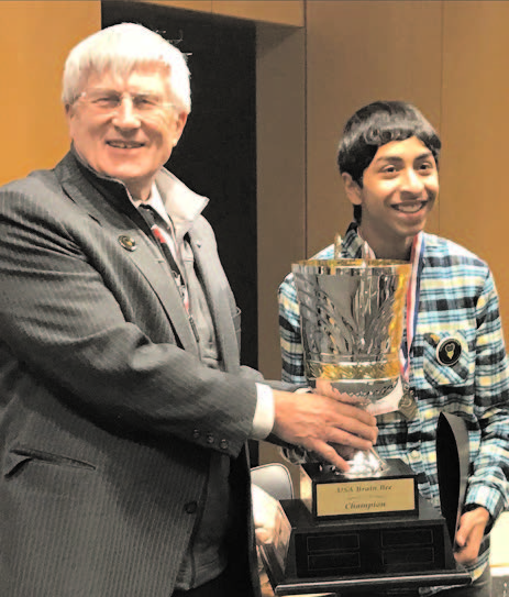 Brain Bee founder Norbert Myslinski, PhD, associate professor at the University of Maryland School of Dentistry, presents a trophy to 2017 USA champion Sojas Wagle