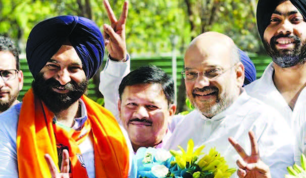BJP president Amit Shah greets BJP-SAD’s Manjinder Singh Sirsa (left) after his victory in New Delhi.